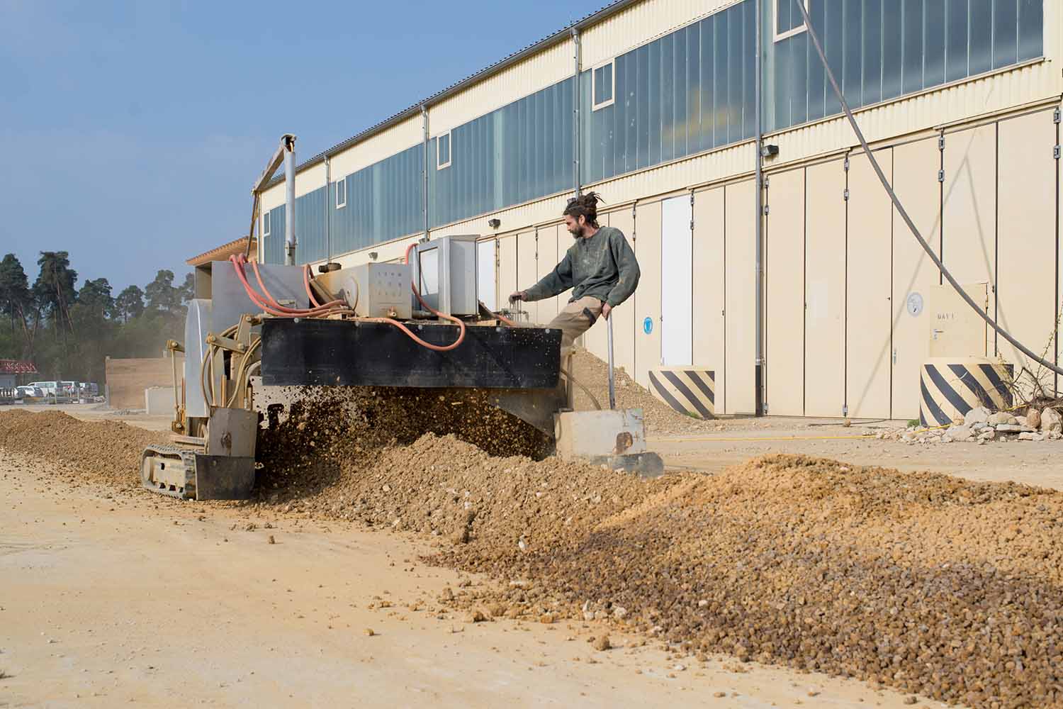 Machine mixing rammed earth aggregate prior to fabrication